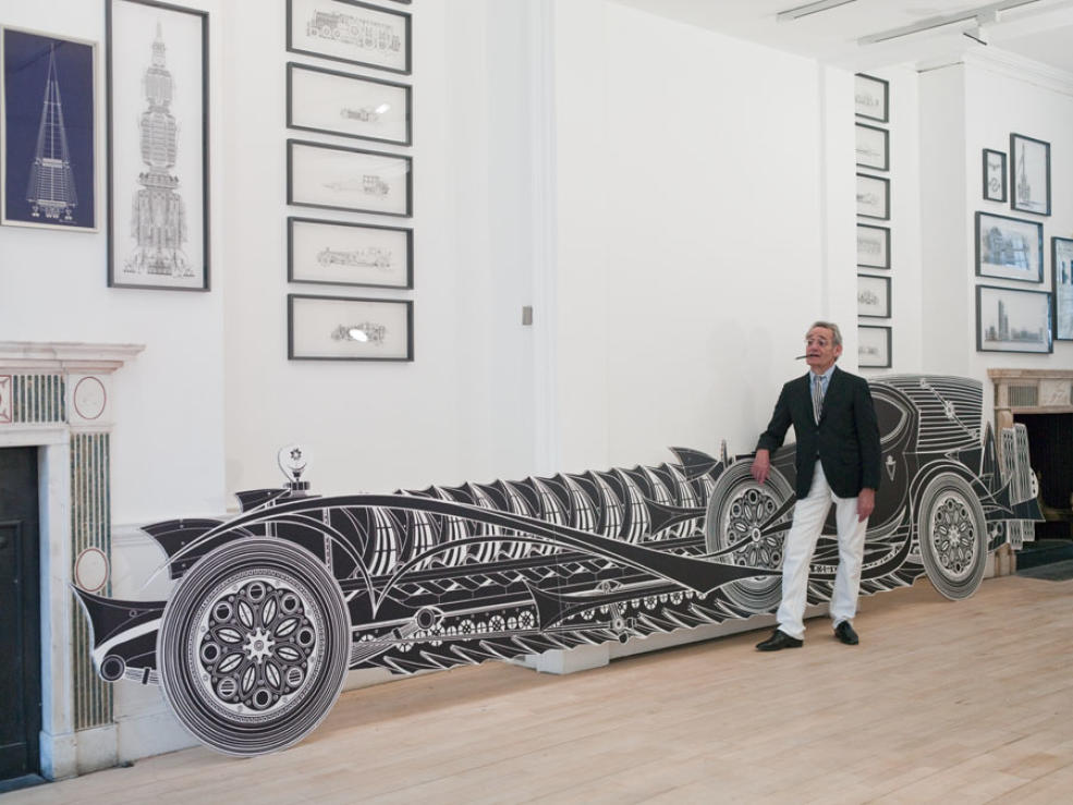 François Dallegret standing in front of his artwork during exhibition opening